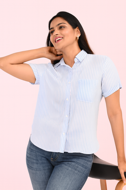Woman wearing Light Blue and White Striped Rayon Shirt from The Classy Clothing, styled with denim jeans for a casual summer look.