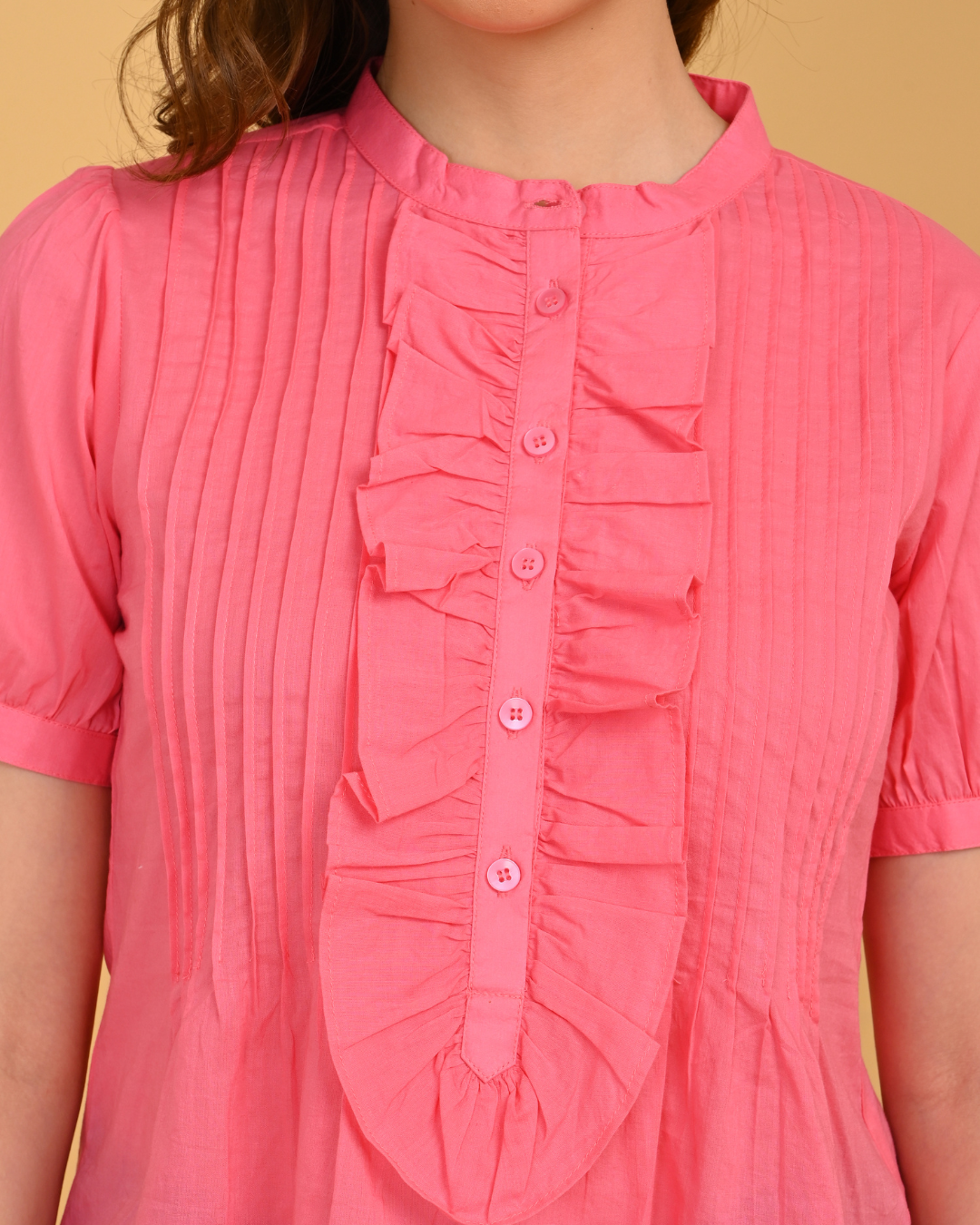 Close-up of pink 100% cotton pintuck ruffle detailing on women’s premium office wear top
