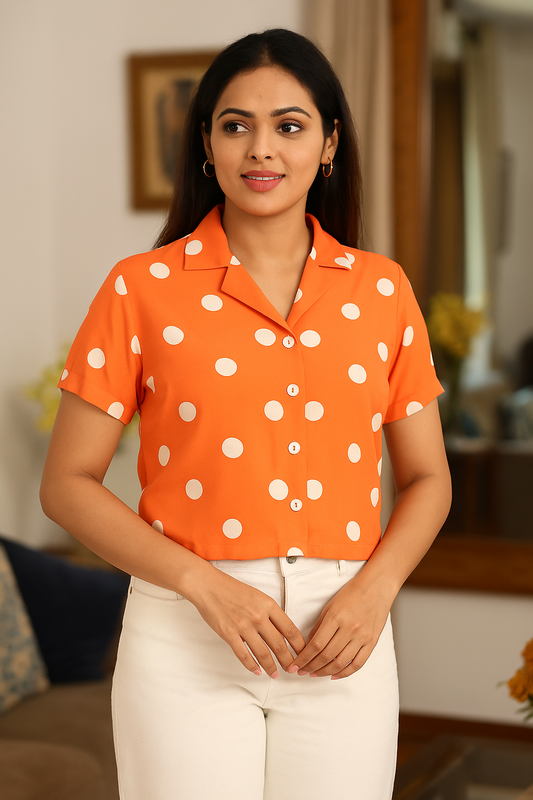 “Woman wearing orange polka dot shirt, front view”