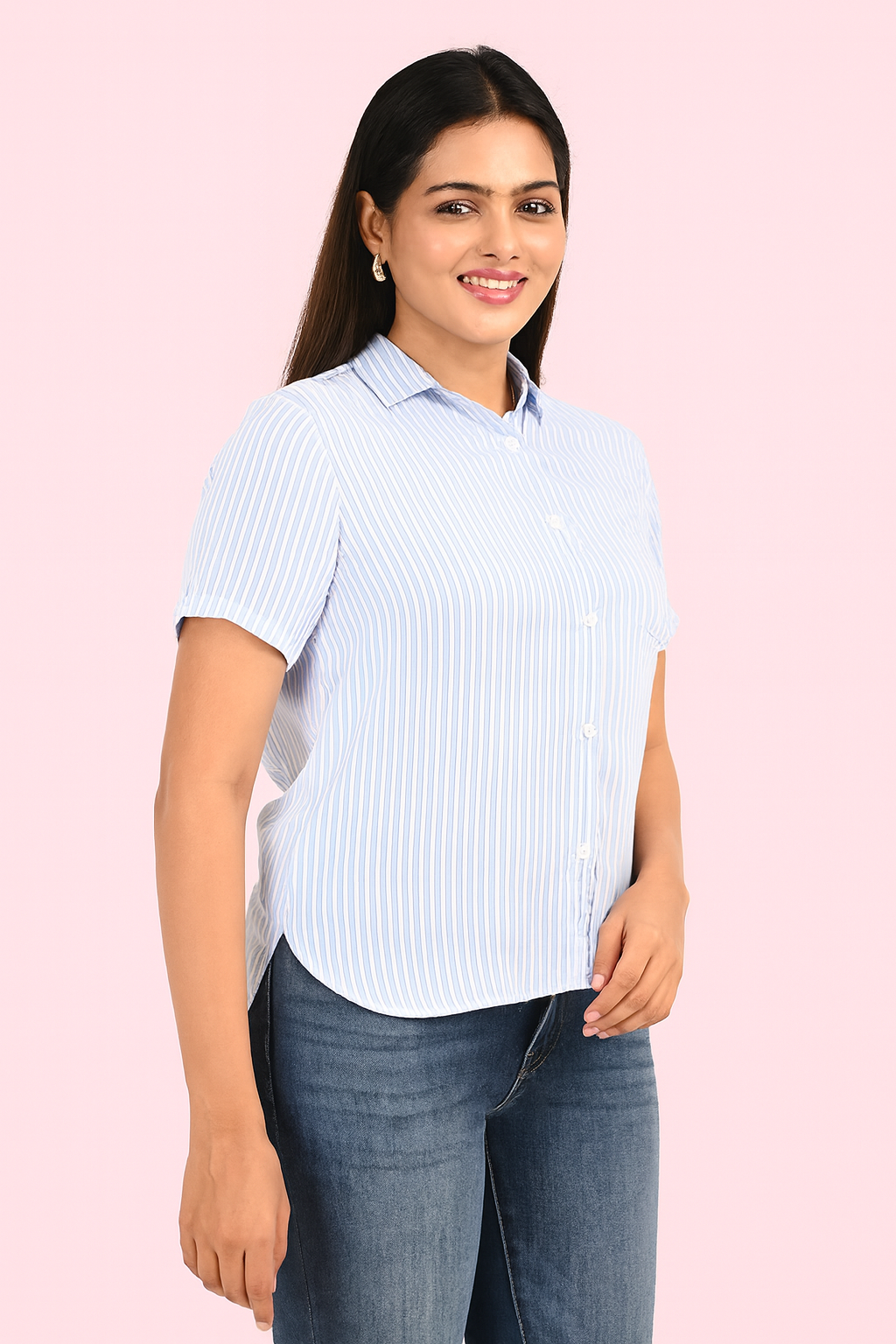 “Woman wearing light blue striped shirt and blue jeans – side angle view showcasing casual and elegant look by Classy Clothing.”
