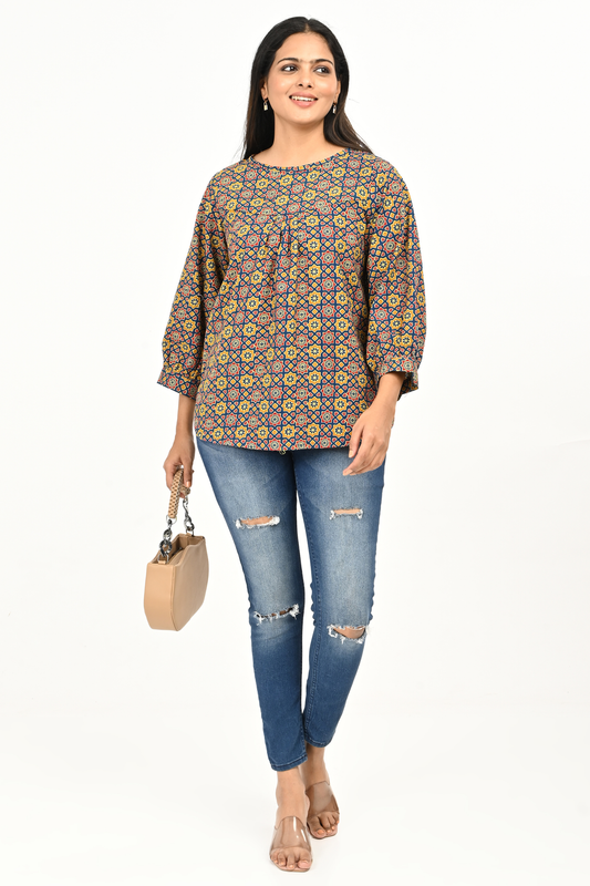 Woman wearing printed cotton top paired with blue jeans, casual everyday women’s top outfit