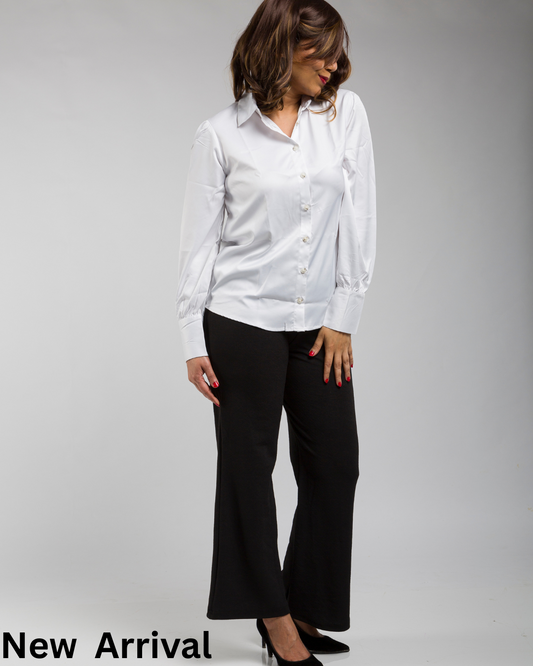 Indian woman wearing a satin shirt styled for an evening party look with elegant festive lighting.