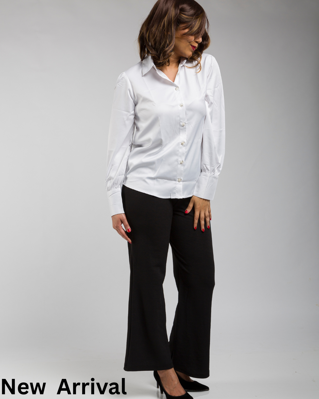 Indian woman wearing a white satin shirt styled with black trousers for an elegant office look.