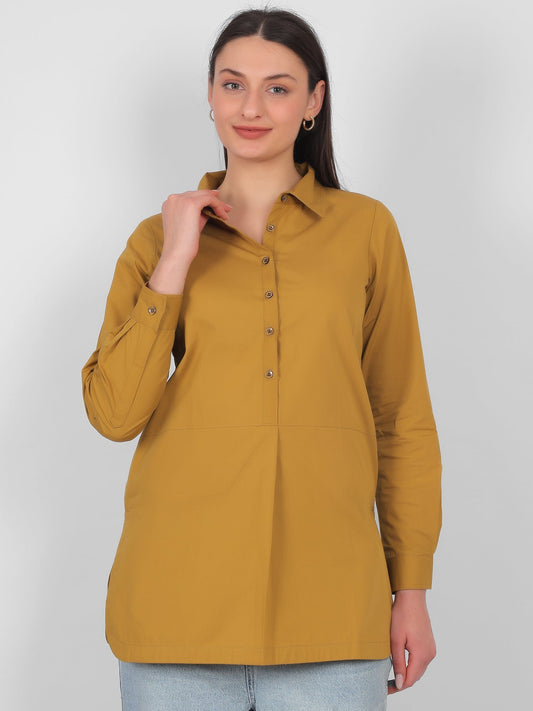 Mustard yellow 100% cotton solid long top for women styled with jeans showing front view and full sleeves ideal for casual and office wear in India