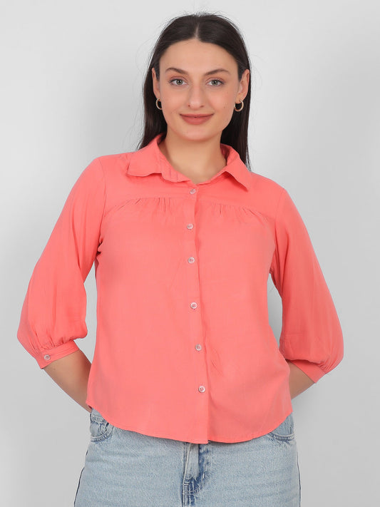Solid coral pink 100% rayon top for women styled with jeans, front view showing collared neckline, front button design and three quarter sleeves, casual and office wear top for Indian women