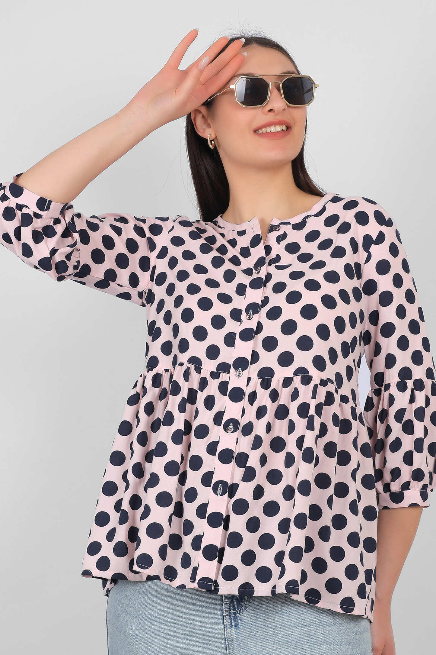 Peach rayon top for women styled for casual wear with button detailing and three quarter sleeves