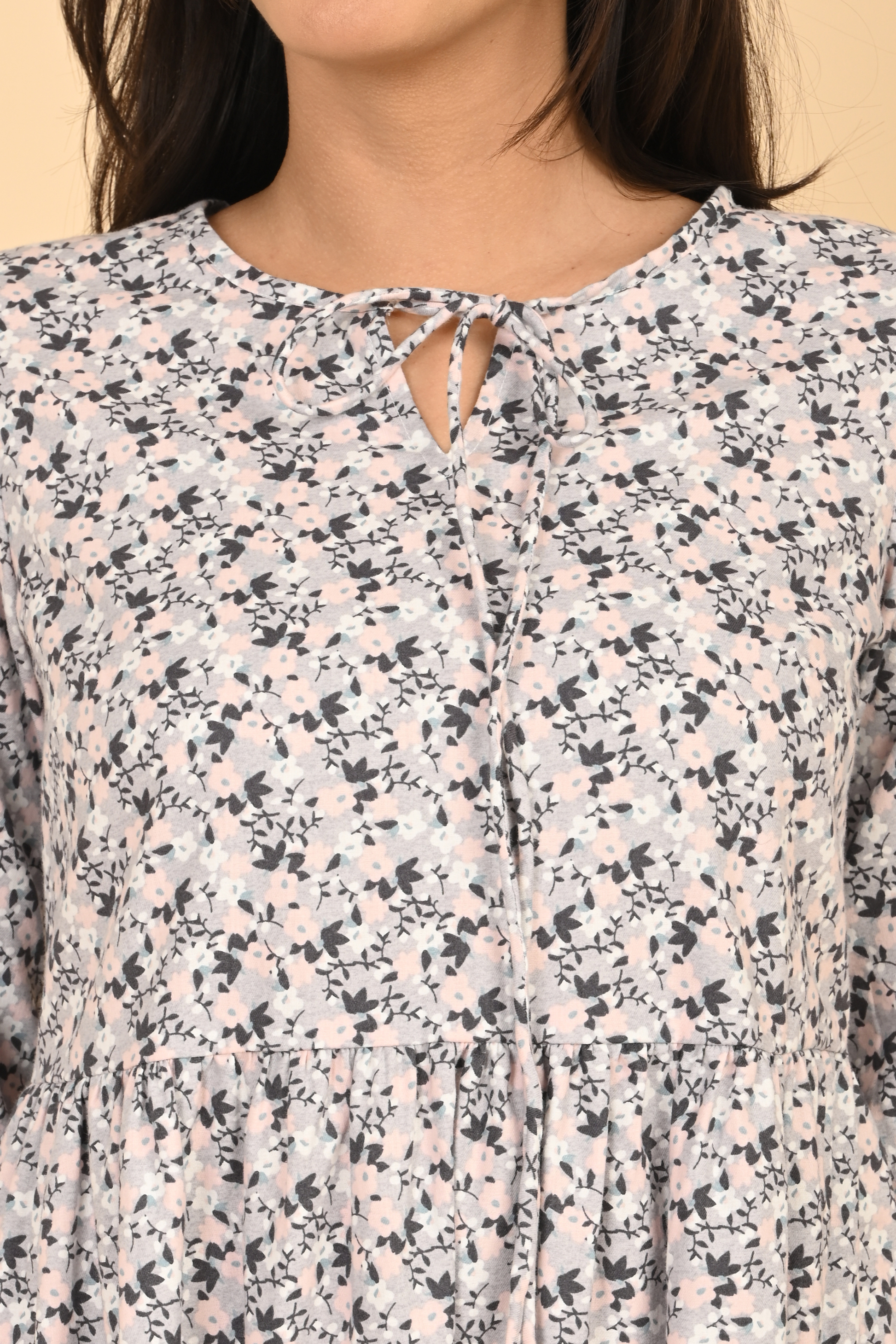 Detail view of tie-up neckline on all over printed rayon dress for women