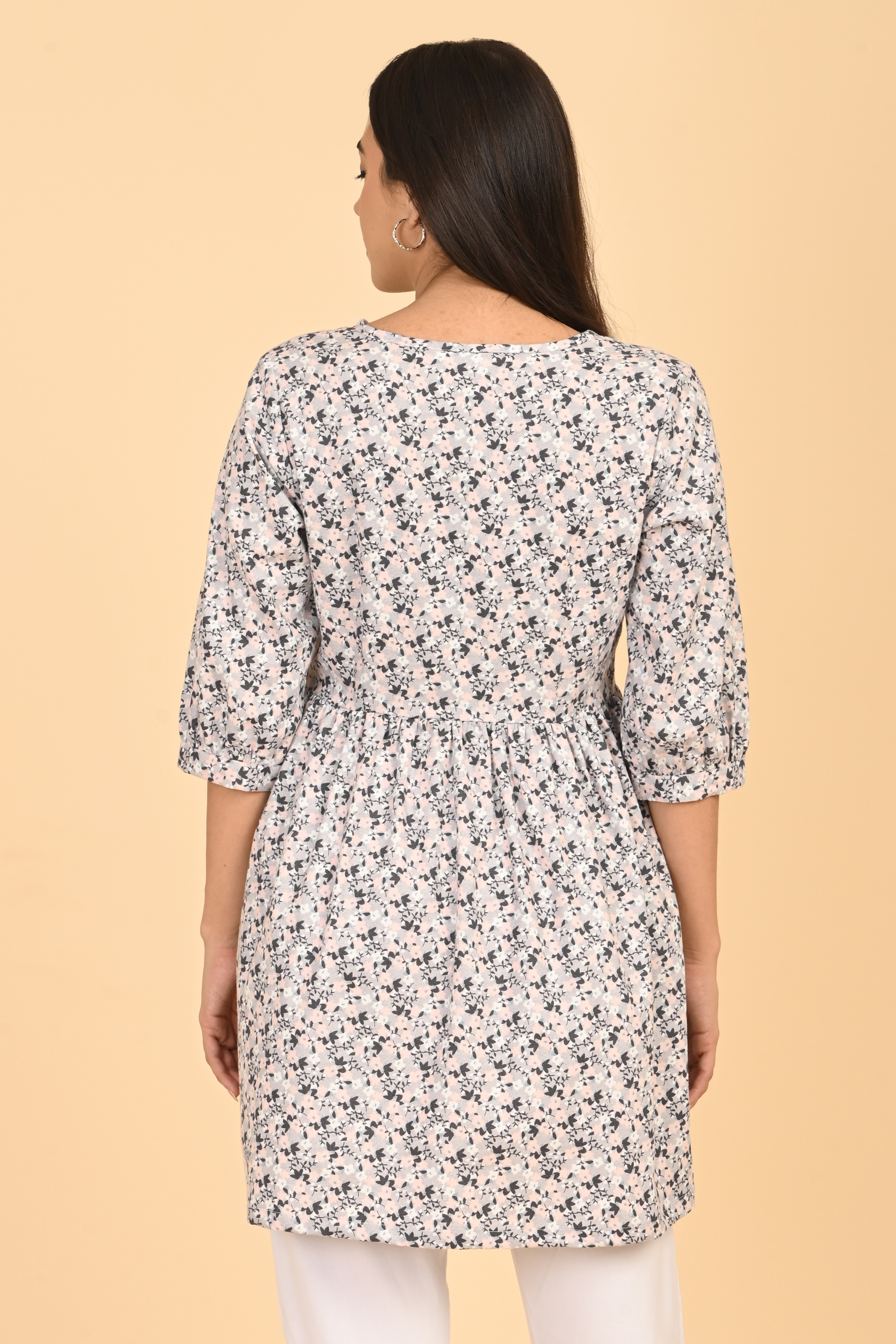 Back view of women wearing all over printed rayon dress for summer wear in India