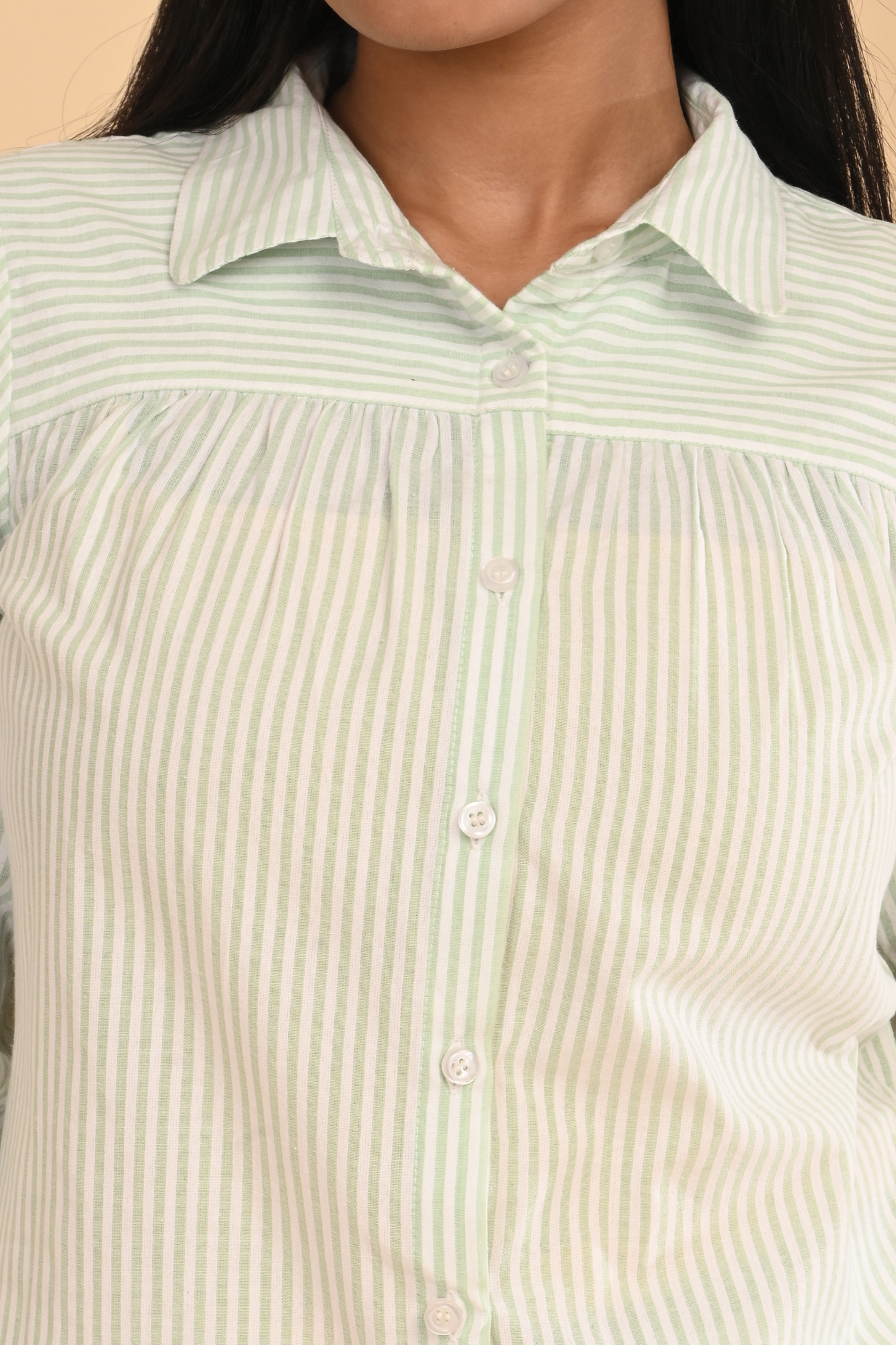 Front close-up of cotton striped yarn dyed top with button placket and yoke detail