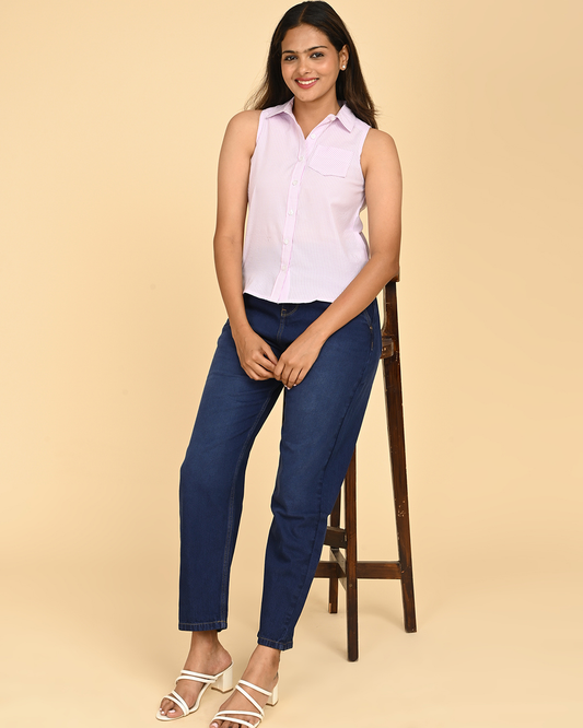 Woman wearing lilac striped sleeveless cotton shirt for women with blue jeans