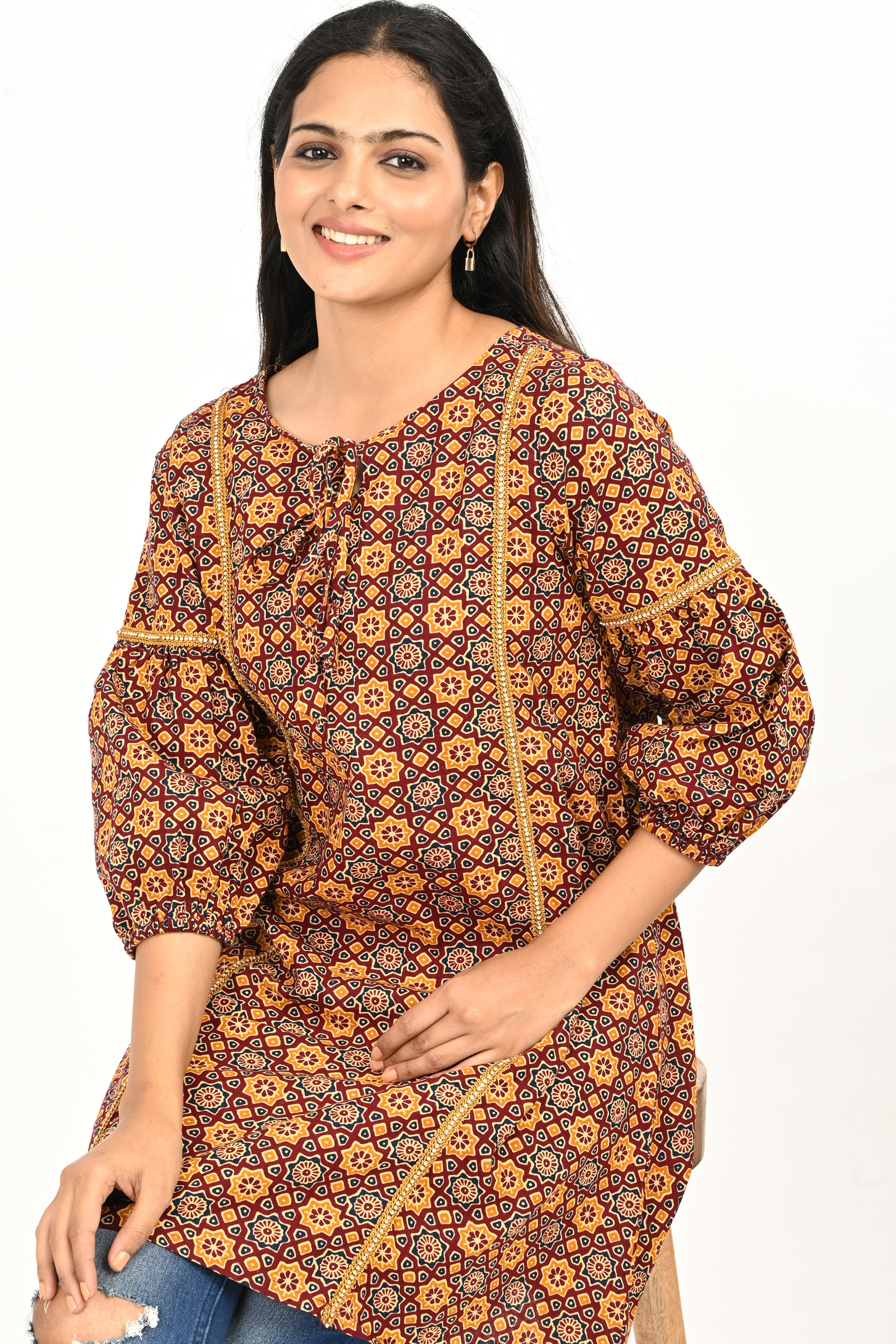 Rust yellow all-over print cotton tunic top styled with jeans – lifestyle pose