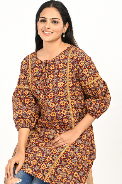 Rust yellow all-over print cotton tunic top styled with jeans – lifestyle pose