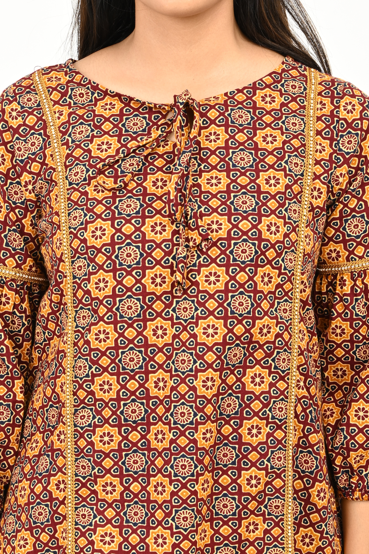 Close-up of neckline and print details of rust yellow 100% cotton tunic top
