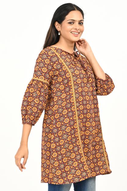 Side view of woman wearing rust yellow printed 100% cotton tunic top