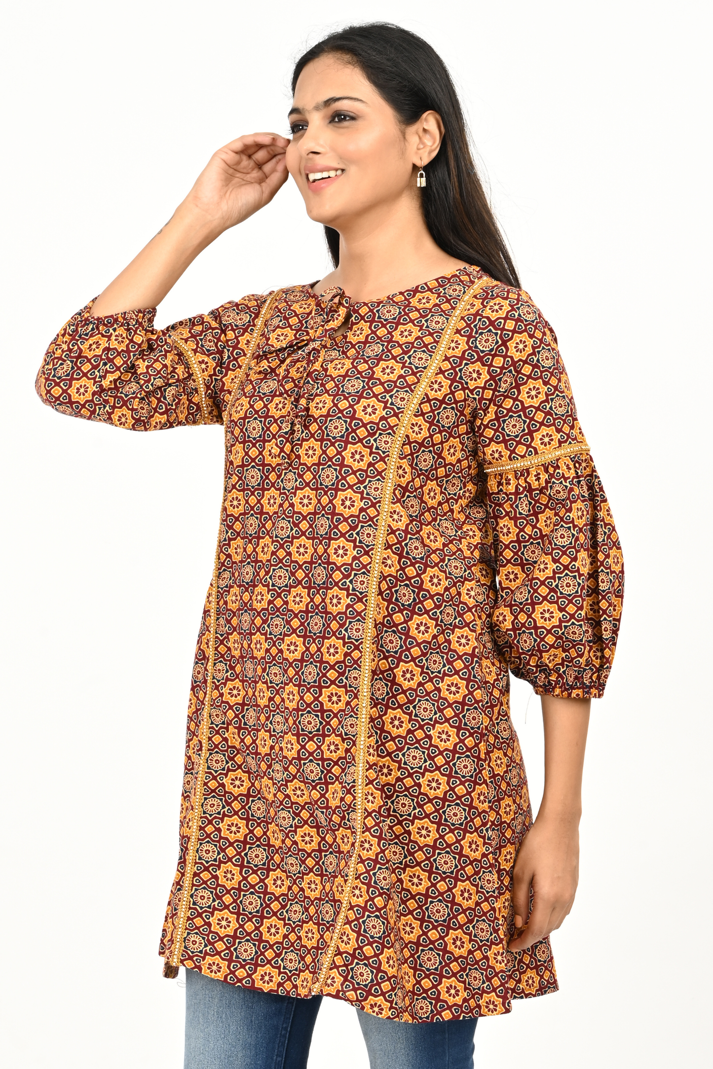 Side view of woman wearing rust yellow printed 100% cotton tunic top