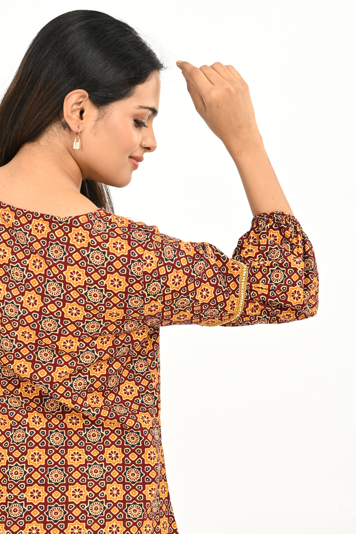 Sleeve detail of rust yellow all-over print balloon sleeve cotton tunic top