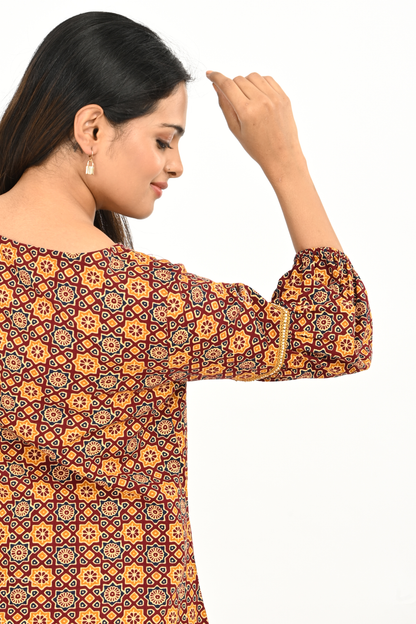 Sleeve detail of rust yellow all-over print balloon sleeve cotton tunic top