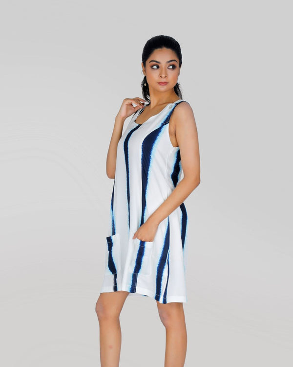 Woman wearing blue and white tie-dye sleeveless rayon dress with functional side pocket – perfect for brunch or casual outings.