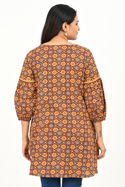 Back view of rust yellow all-over print 100% cotton tunic top for women