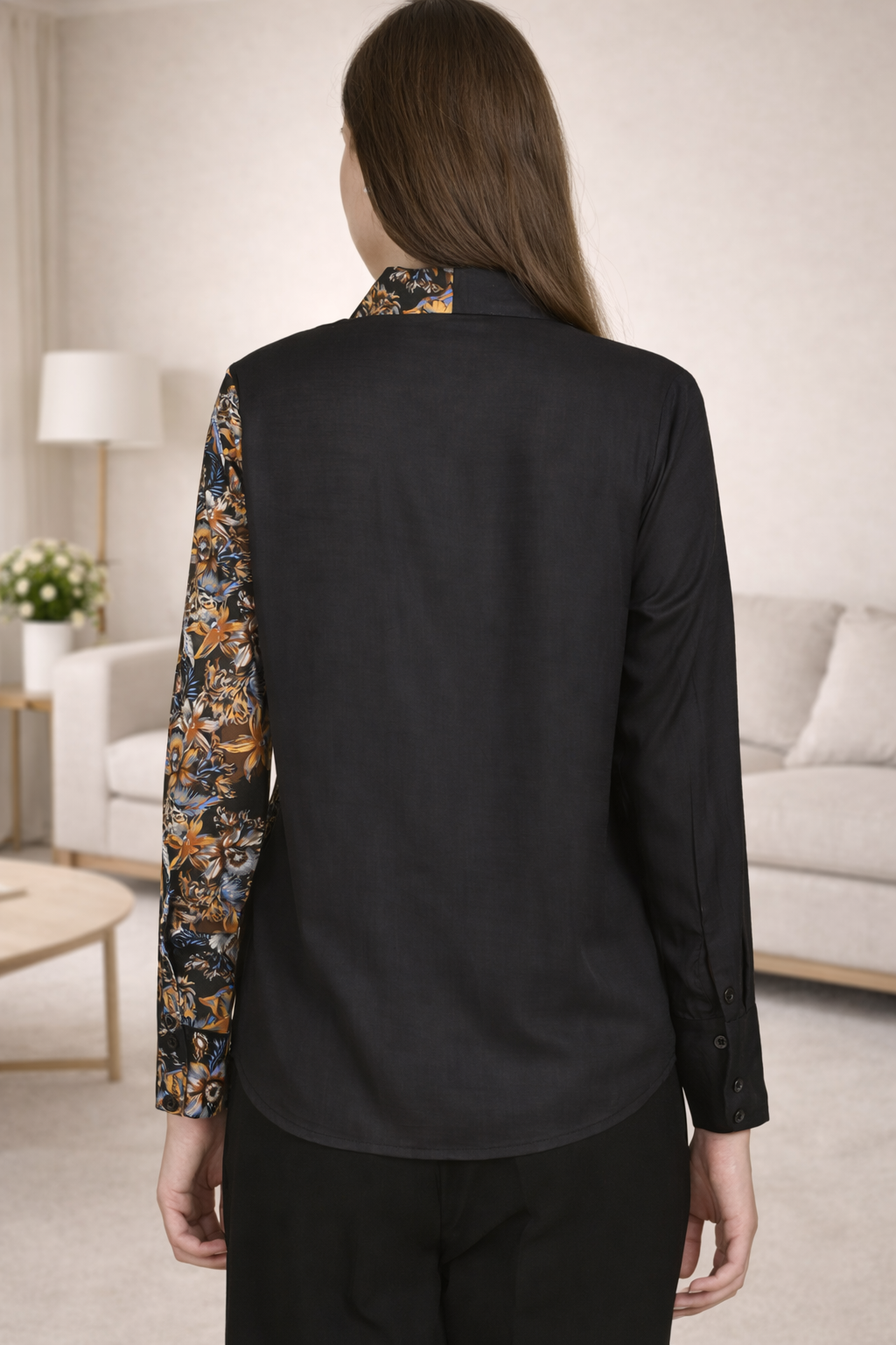 Back view of the women's long-sleeved black printed shirt showing the clean drape and floral pattern continuity.