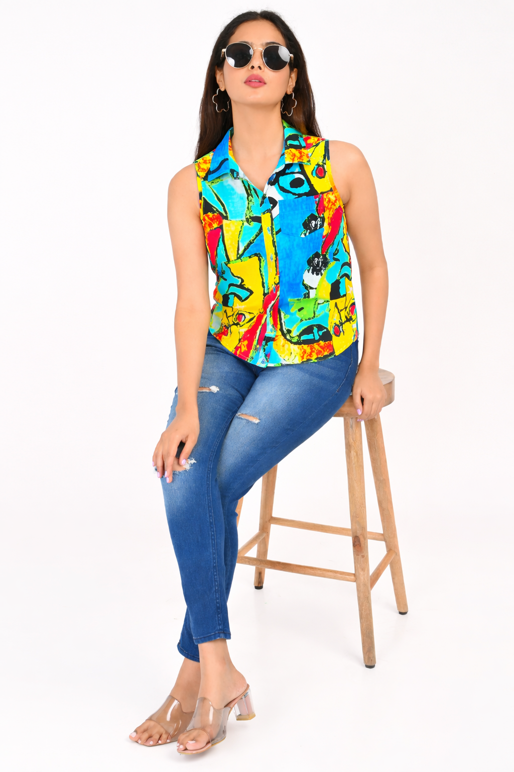 Sleeveless abstract print rayon shirt for women paired with blue jeans, Western wear made in India