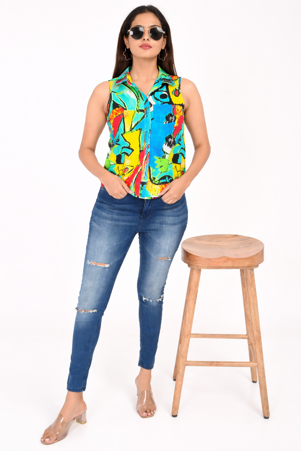 Front view of sleeveless abstract print rayon shirt for women styled with jeans, lightweight Western wear made in India