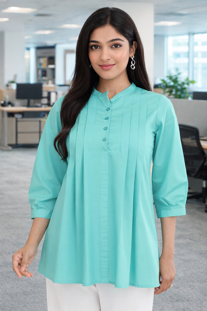 Office wear top for women in mint green, pleated cotton work tunic worn in office setting
