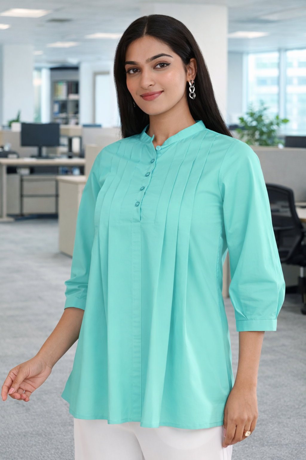 Mint green pleated cotton office wear top for women, front angle view in office setting
