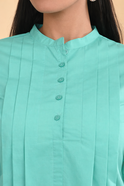 Close-up of mint green pleated cotton office wear top for women with band collar and button placket