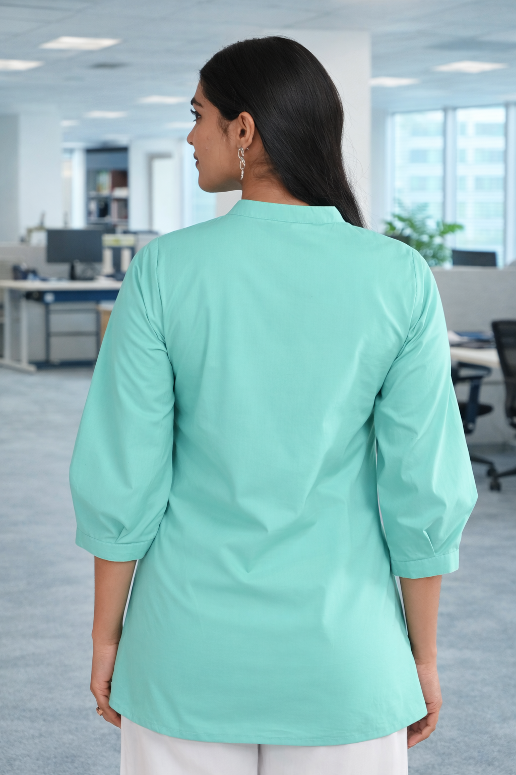 Back view of mint green pleated cotton office wear top for women in office setting