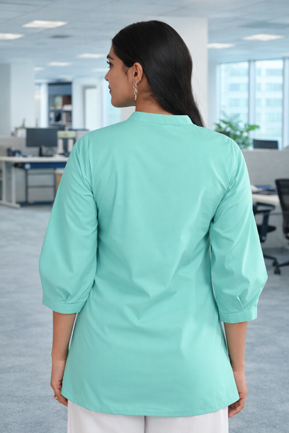 Back view of mint green pleated cotton office wear top for women in office setting