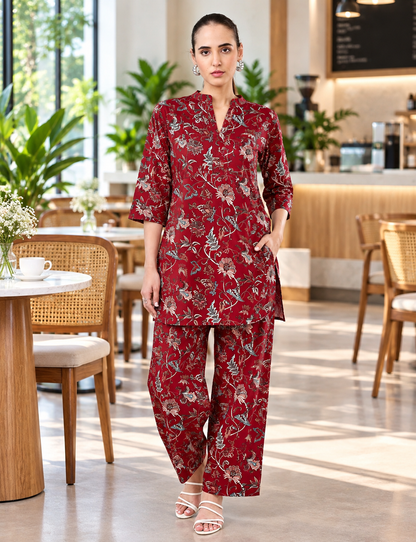 Burgundy floral printed co-ord set for women featuring a matching tunic and wide-leg pants, styled in a modern Bangalore cafe – Classy Clothing India