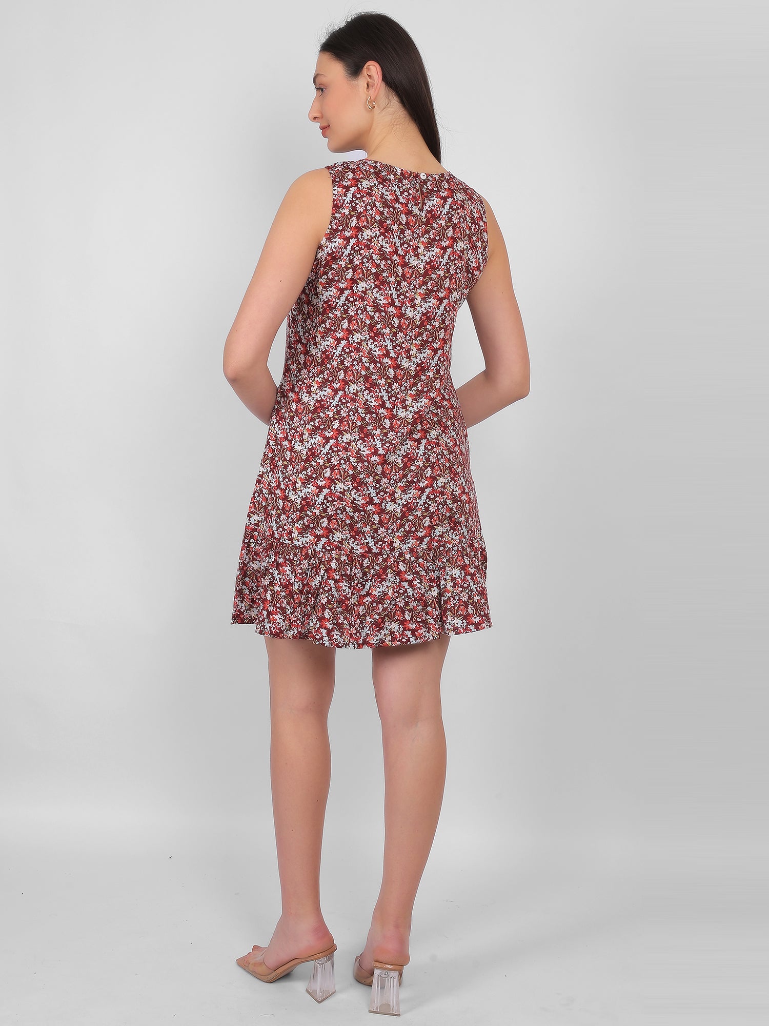 Woman wearing all over printed rayon dress for women in India, back view sleeveless summer dress in lightweight breathable fabric for casual wear