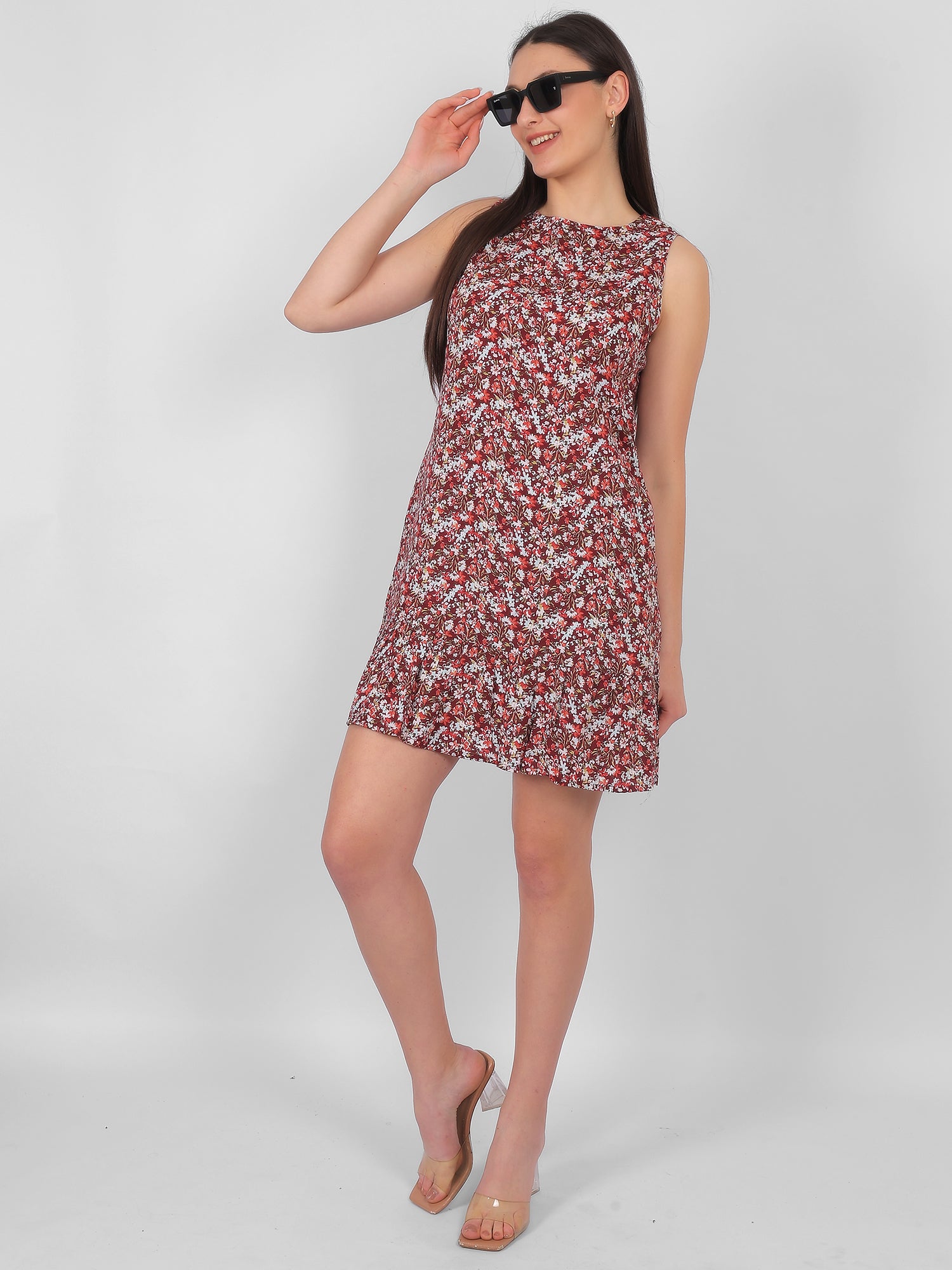 Woman wearing all over printed rayon dress for women in India, trendy sleeveless summer dress styled with sunglasses in lightweight breathable fabric for casual outings