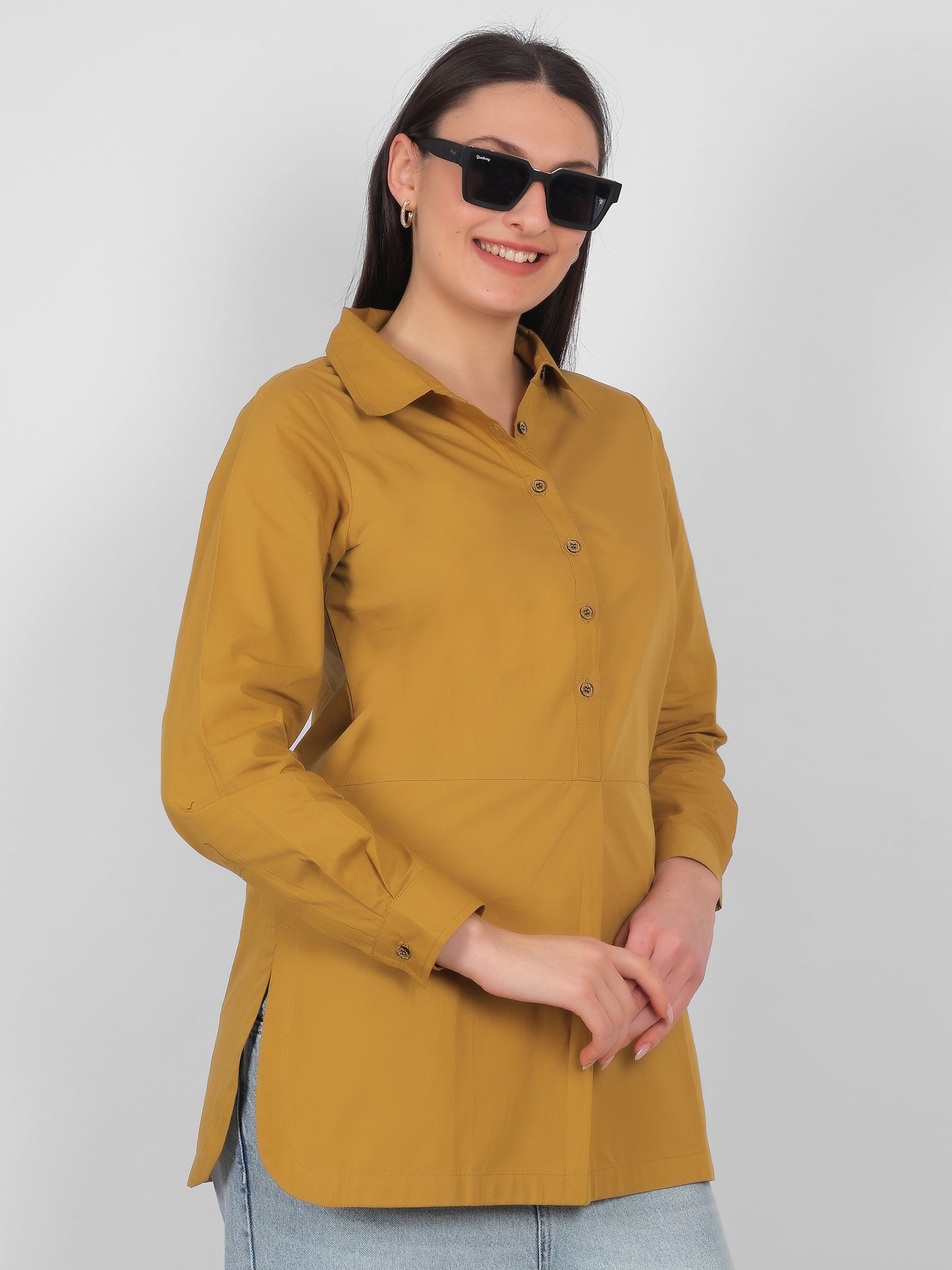 Side view of mustard yellow 100% cotton solid long top for women with full sleeves styled for casual and office wear in India