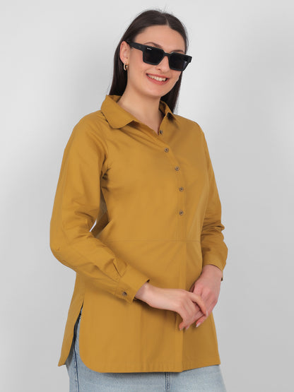 Side view of mustard yellow 100% cotton solid long top for women with full sleeves styled for casual and office wear in India
