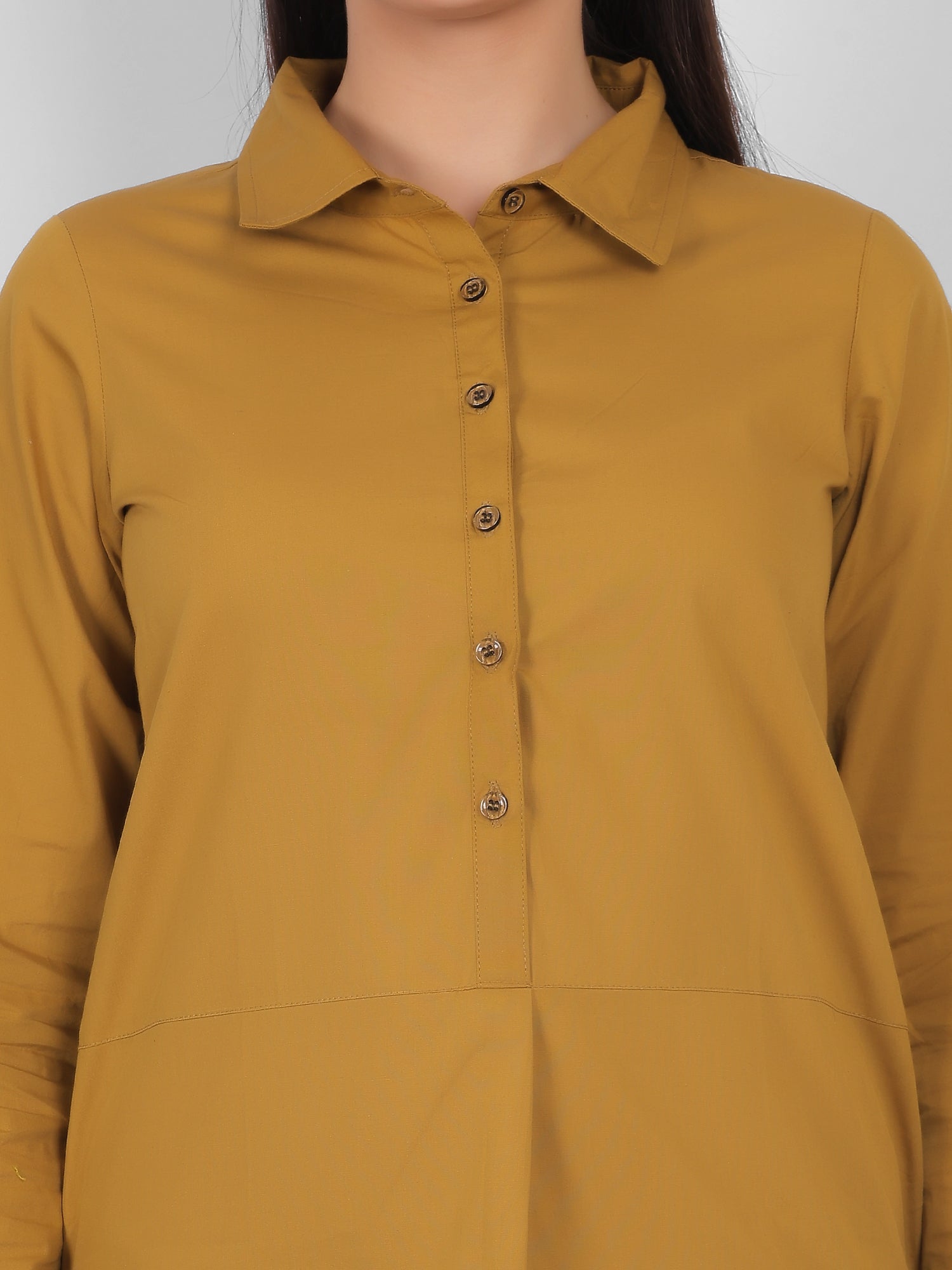 Close up view of mustard yellow 100% cotton solid long top for women showing collar button placket and soft breathable fabric detail