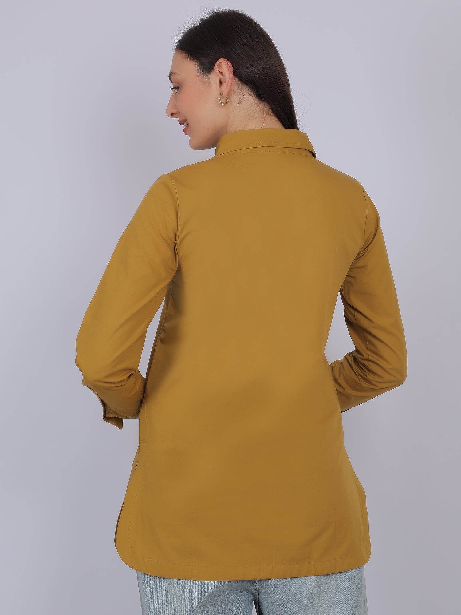 Back view of mustard yellow 100% cotton solid long top for women with full sleeves showing straight fit and smooth fabric finish ideal for everyday wear in India