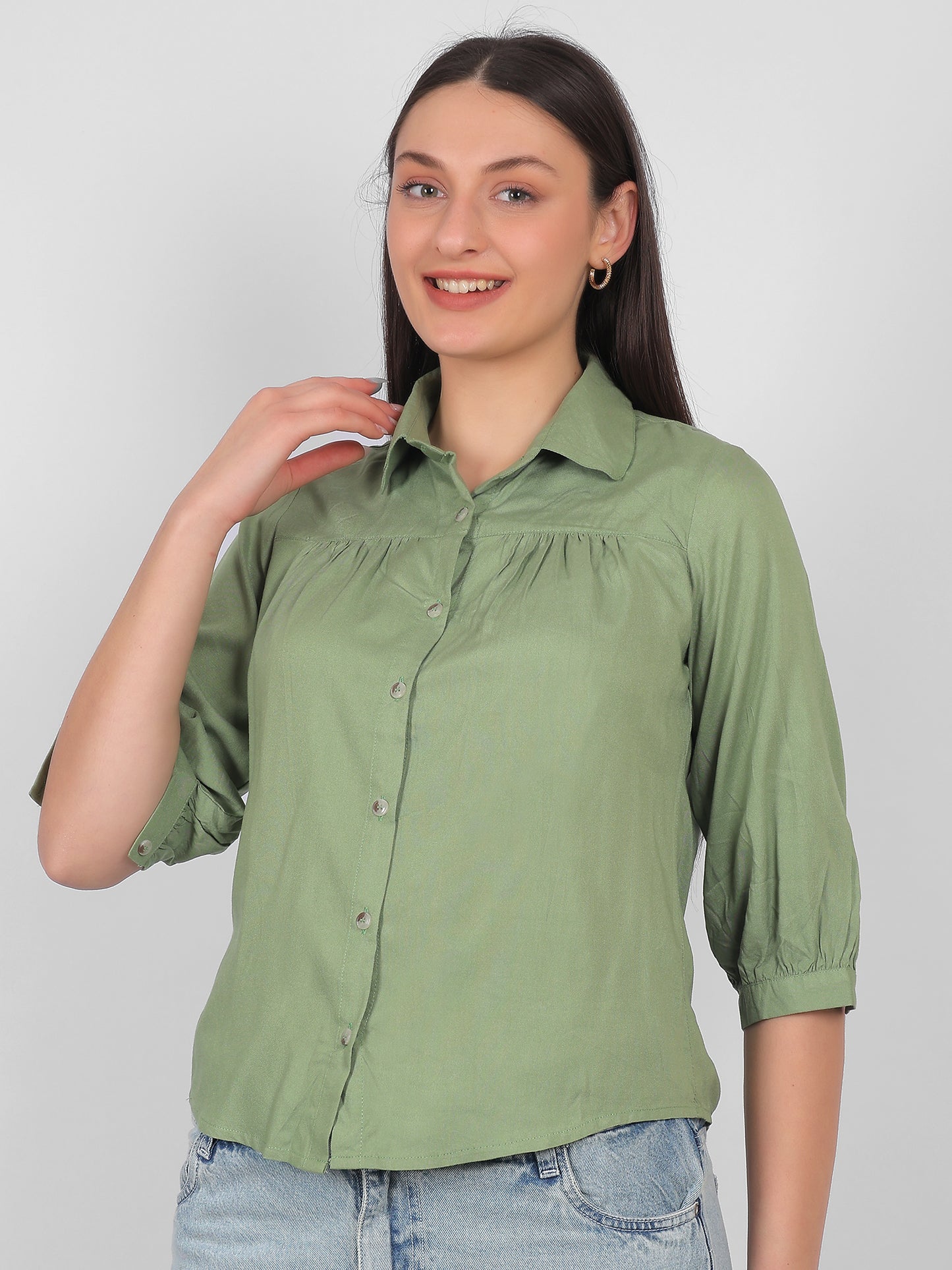 Solid green 100% rayon top for women shown from side angle with collared neck, front buttons and three quarter sleeves, stylish casual and office wear top for Indian women
