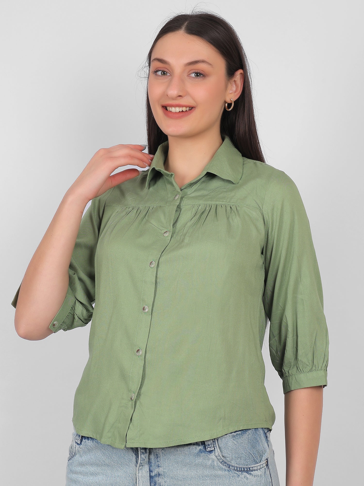 Solid green 100% rayon top for women shown from side angle with collared neck, front buttons and three quarter sleeves, stylish casual and office wear top for Indian women