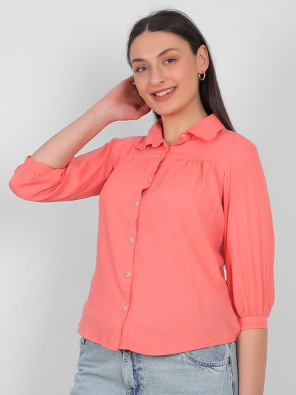 Solid coral pink 100% rayon top for women with collared neckline, front button design and three quarter sleeves, front view casual and office wear top for Indian women