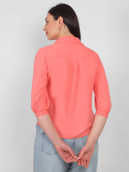 Solid coral pink 100% rayon top for women showing back view with collared neckline and three quarter sleeves, breathable casual and office wear top for Indian women