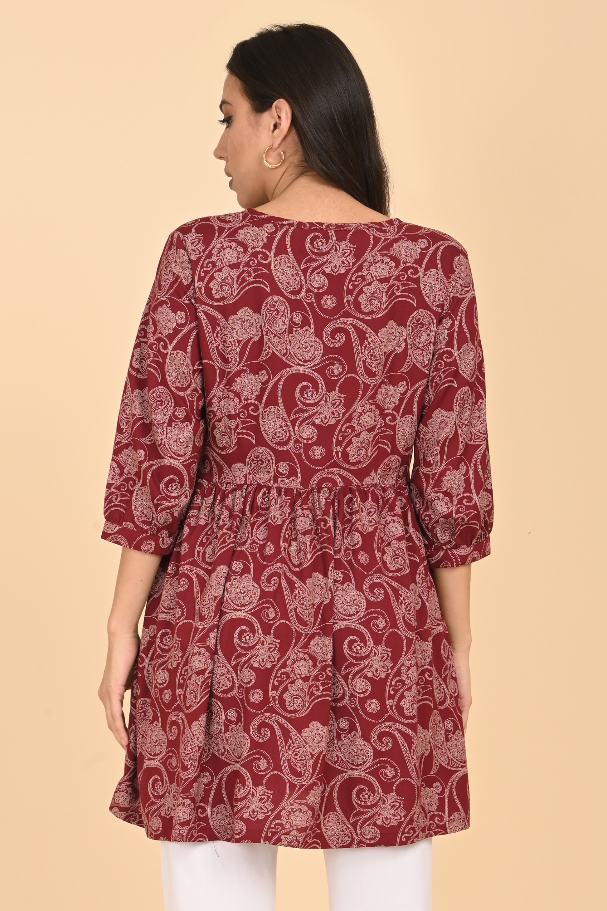 Back view of the maroon paisley tunic, showcasing its flowy silhouette and length.