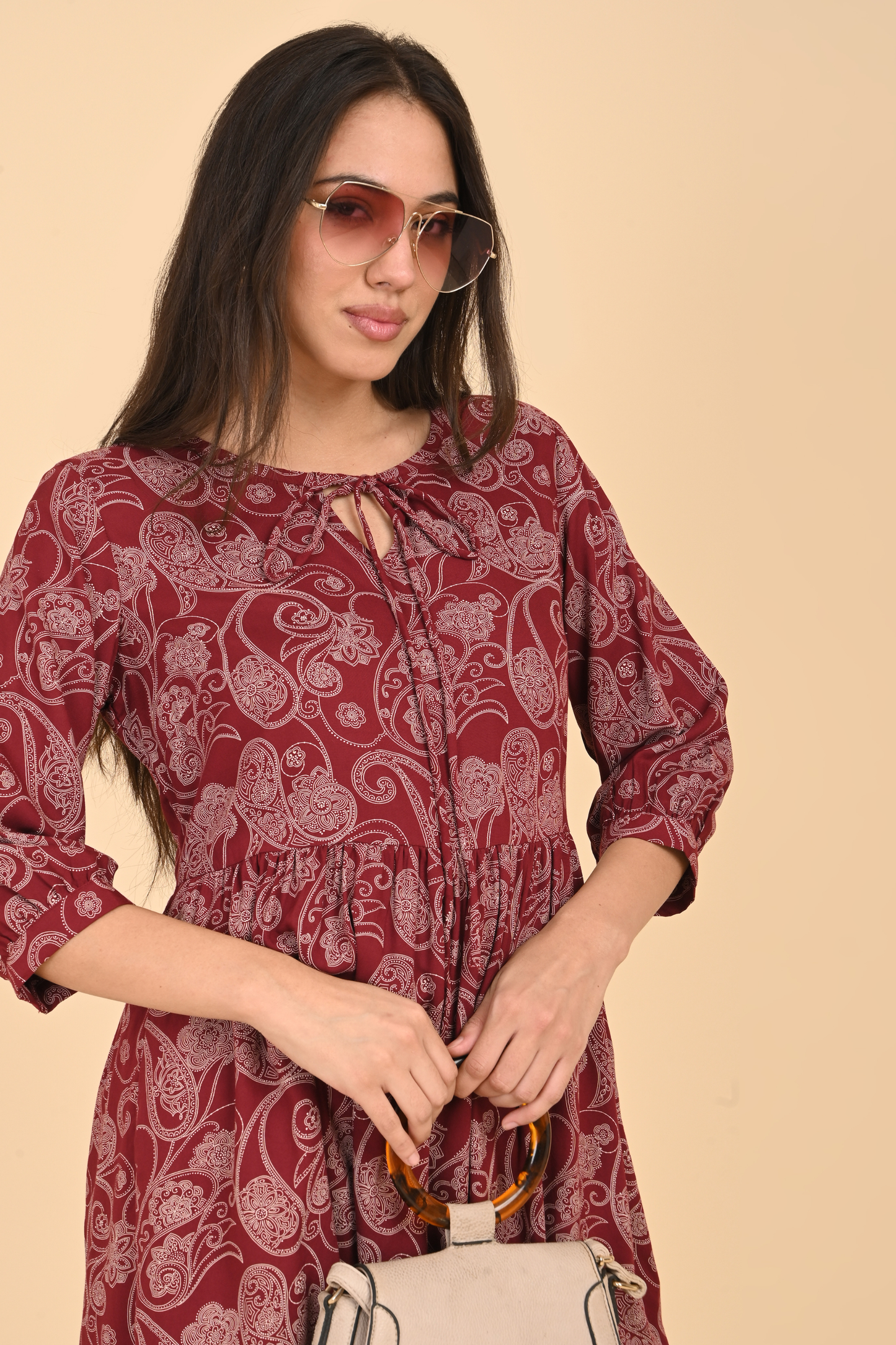 Model wearing the maroon paisley print tunic, styled for a casual and comfortable everyday look.