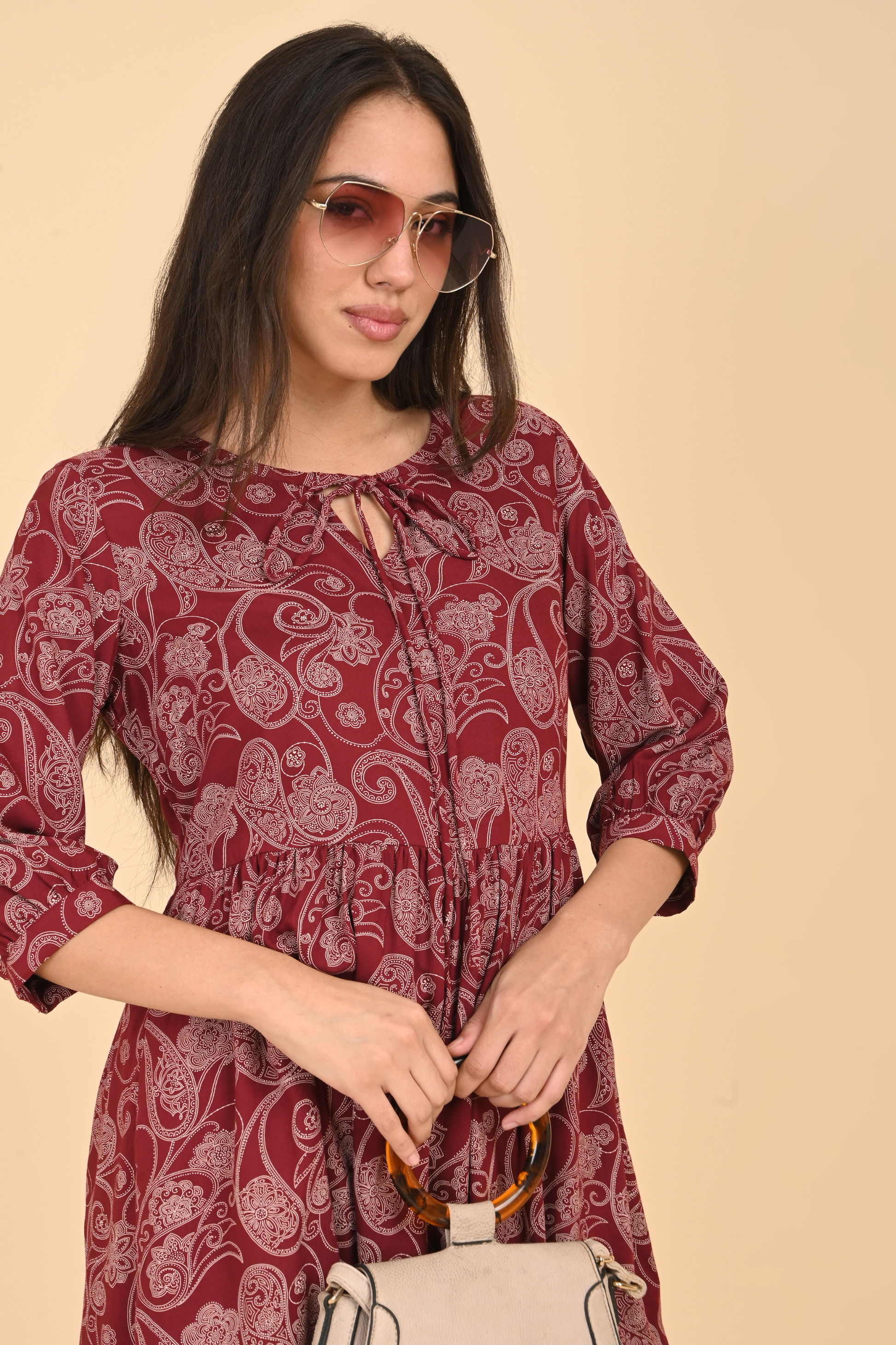 Model wearing the maroon paisley print tunic, styled for a casual and comfortable everyday look.