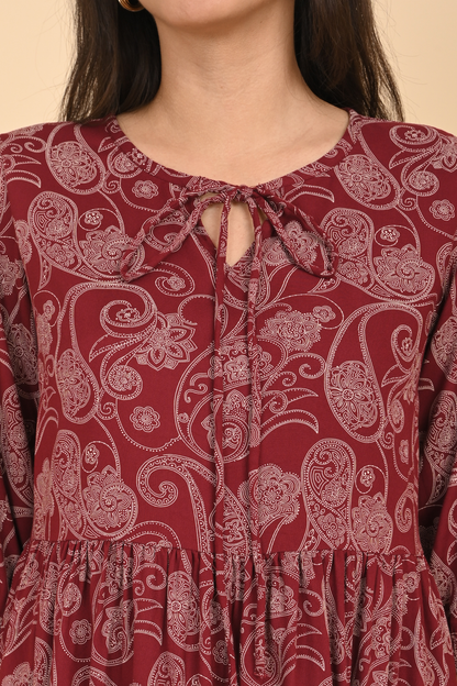 Detail of the neck line and delicate stitching on the maroon paisley print rayon tunic.