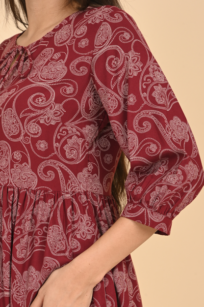 Detail of the sleeve and delicate stitching on the maroon paisley print rayon tunic.