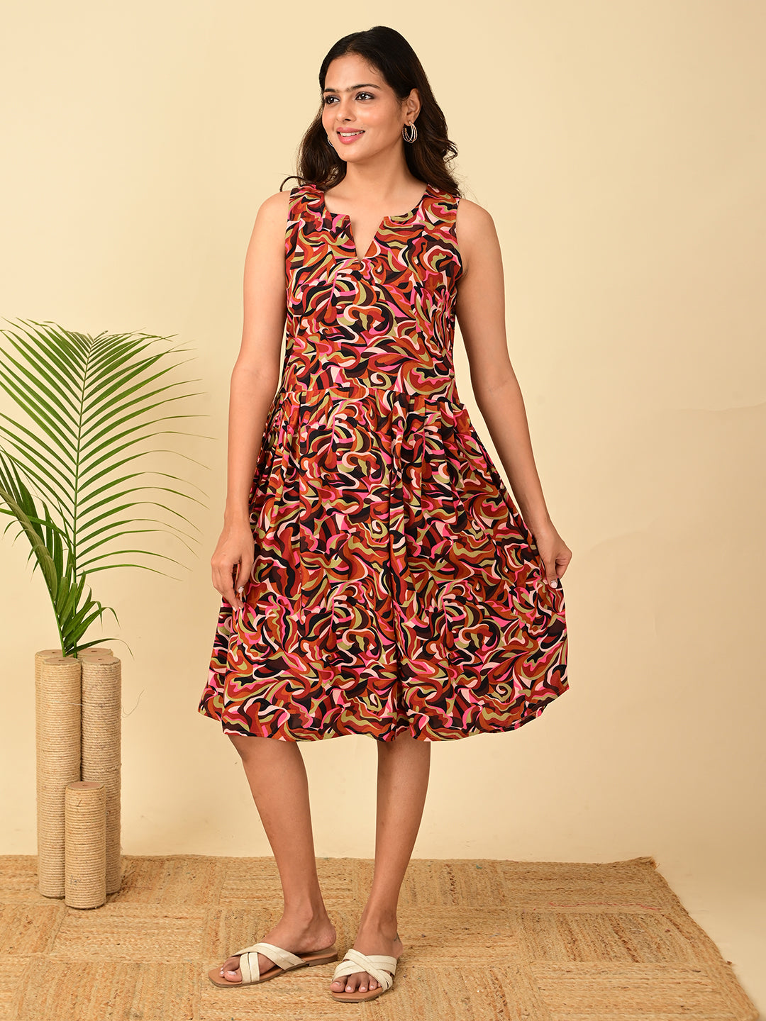 Multicolor all-over printed rayon fit and flare midi dress for women in India with sleeveless design, soft breathable fabric, abstract print, and comfortable everyday casual wear.