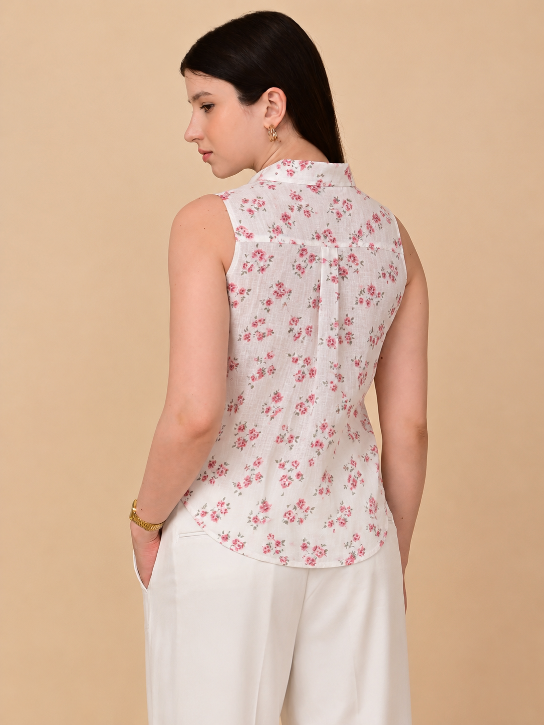 White floral sleeveless shirt for women, back view with pink rose print and curved hem